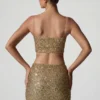Top corto con aberturas y adornos Ariana en dorado