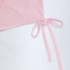 Top corto cruzado Lou de punto calado en rosa bebé