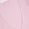 Top corto cruzado Lou de punto calado en rosa bebé