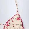 Top de bikini triangular Noia en rojo con estampado floral