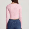 Top de manga larga con escote pronunciado de encaje transparente Lioren en rosa