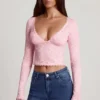 Top de manga larga con escote pronunciado de encaje transparente Lioren en rosa