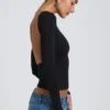 Top Elli de modal con cuello alto, manga larga y espalda abierta en negro