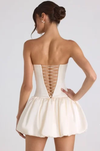 Vestido corsé con bajo abullonado y cordones Fabiola en color marfil