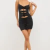 Vestido corto Aniela de jersey elástico con detalles de rosas y aberturas en negro Vestido corto Aniela de jersey elástico con detalles de rosas y aberturas en negro