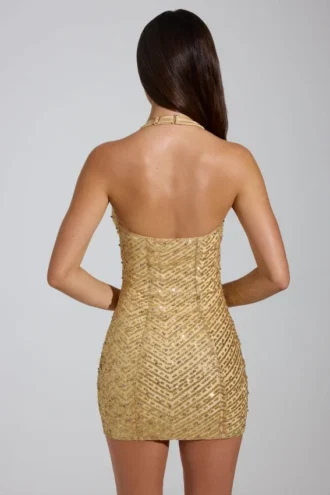 Vestido corto con cuello halter y adornos de Arlona en dorado