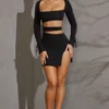 Vestido corto de manga larga con aberturas Enya en negro Vestido corto de manga larga con aberturas Enya en negro