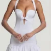 Vestido corto Millie con cuello halter, detalle de lazo y bajo abullonado en blanco Vestido corto Millie con cuello halter, detalle de lazo y bajo abullonado en blanco