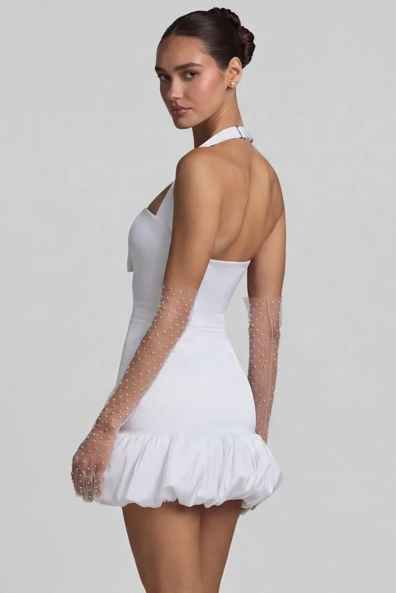 Vestido corto Millie con cuello halter, detalle de lazo y bajo abullonado en blanco Vestido corto Millie con cuello halter, detalle de lazo y bajo abullonado en blanco