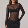 Vestido corto Noel de manga larga con cuello alto y adornos transparentes en negro Vestido corto Noel de manga larga con cuello alto y adornos transparentes en negro
