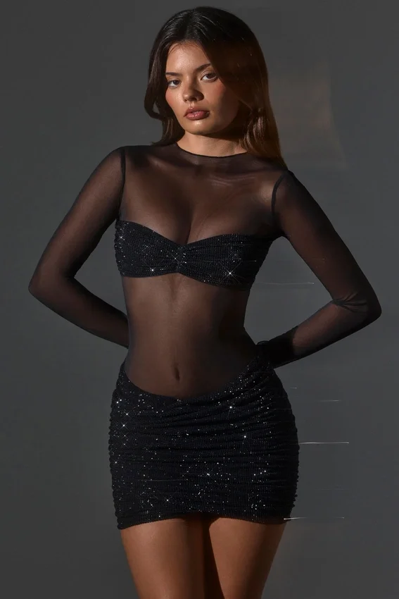 Vestido corto Noel de manga larga con cuello alto y adornos transparentes en negro Vestido corto Noel de manga larga con cuello alto y adornos transparentes en negro