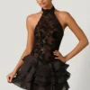 Vestido corto Petalia con volantes y cuello halter adornado en negro Vestido corto Petalia con volantes y cuello halter adornado en negro