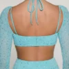 Vestido largo con cuello vuelto y adornos Champel en color aguamarina