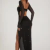 Vestido largo con cuello vuelto y adornos de Champel en negro