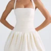 Vestido micro corto con corsé, cuello halter y bajo abullonado con cordones Ludmila en color marfil